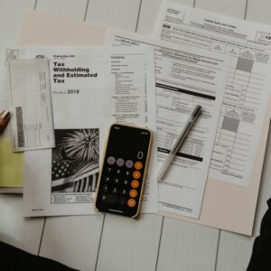 Documents financiers et calculatrice sur un bureau, illustration du financement des factures